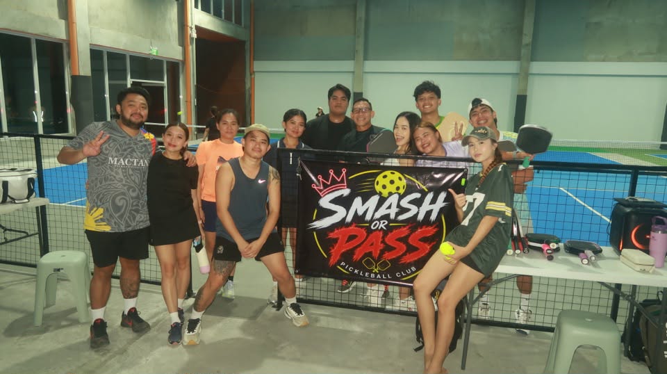 Group gathered around the Smash or Pass Pickleball Club banner