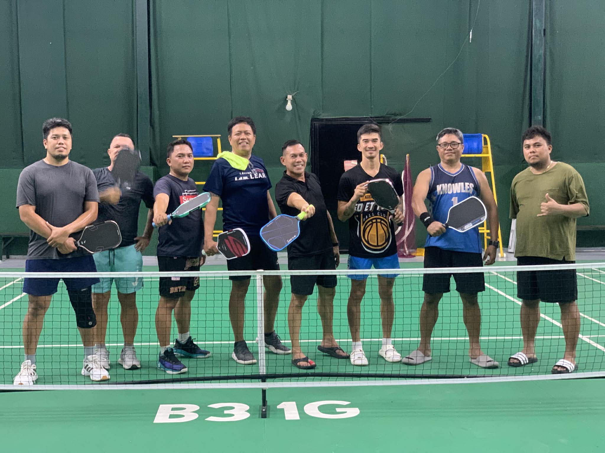 Players holding paddles at the net